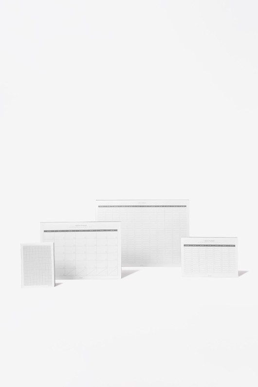 four-planners-standing-front-white-calendars