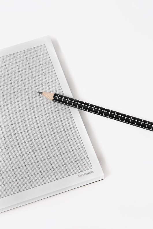 notepad-opened-with-black-pencil
