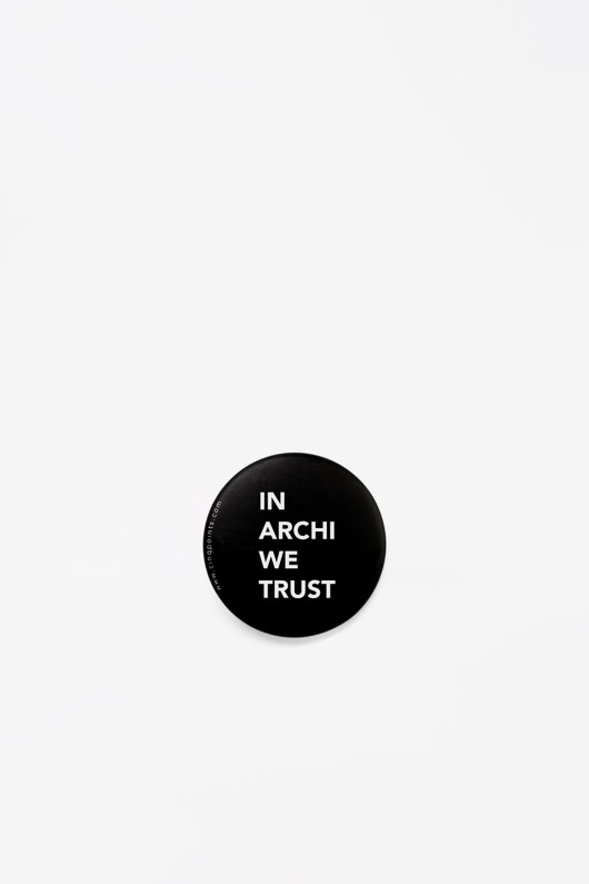 round black metal badge in archi we trust front view