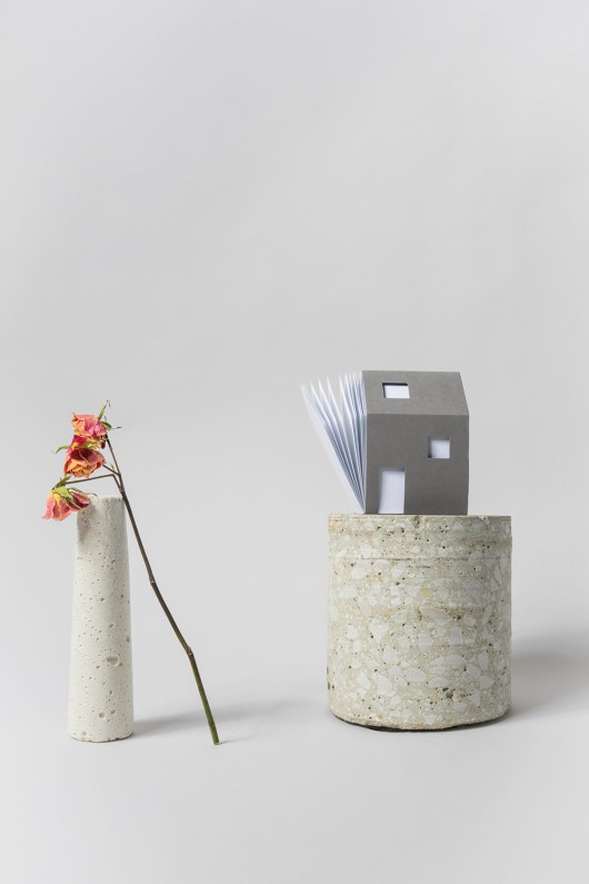 grey-house-shaped-notepad-on-pot-with-vase-and-flower