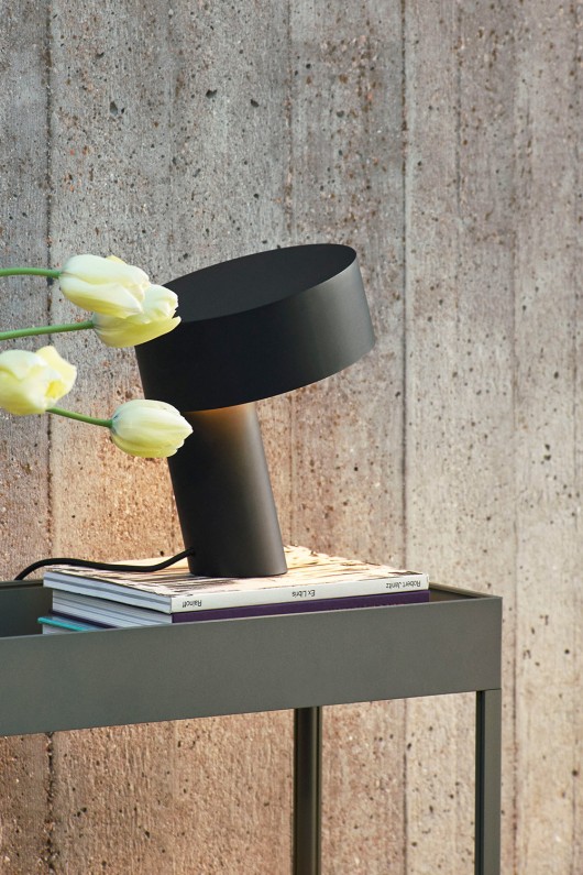 black slant lamp on table with flower