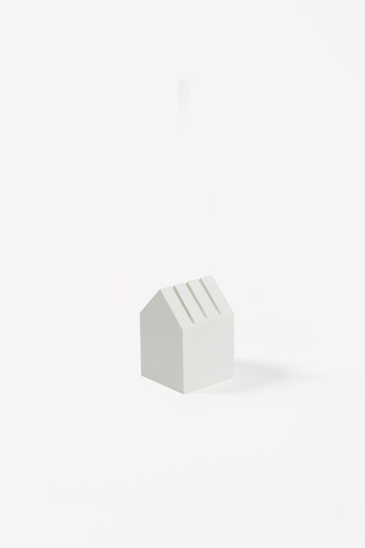 white wooden house-shaped card holder